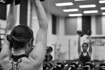 Rear view of woman exercising in gym