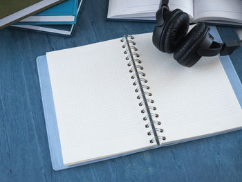 High angle view of book with headphones on table