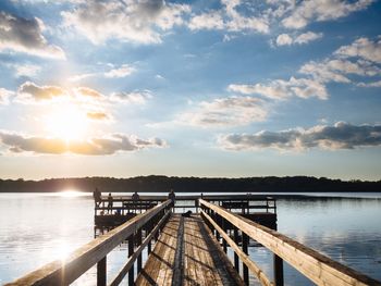 Pier on sea at sunset