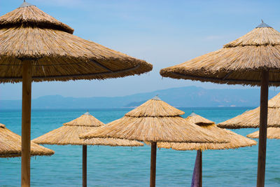 Gazebo on beach against clear sky