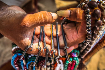 Close-up of man selling jewelry outdoors