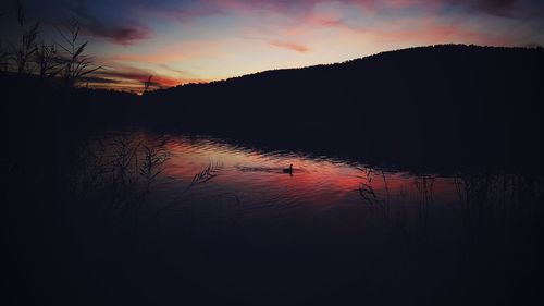 Scenic view of lake against sky at sunset