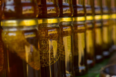 Close-up of wine bottles on shelf at store