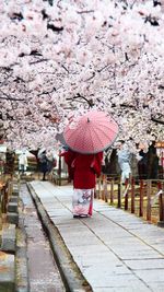 Woman walking on footpath