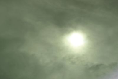 Low angle view of sun shining in sky