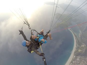 High angle view of friends parasailing