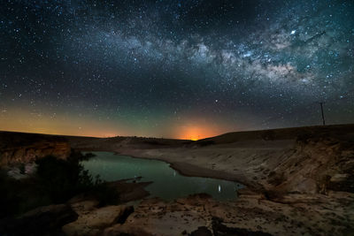 Scenic view of landscape against sky at night