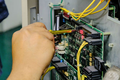 Cropped hand of person repairing electrical equipment