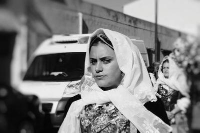 Portrait of woman in traditional clothing on city street