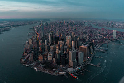 High angle view of buildings by sea against sky