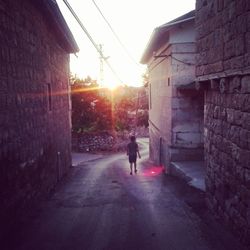 Sun shining through buildings in city