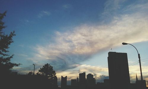 Low angle view of building against cloudy sky