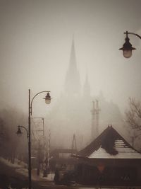 Street light against sky during foggy weather