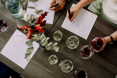 High angle view of businesswoman writing on paper during kick off meeting at convention center