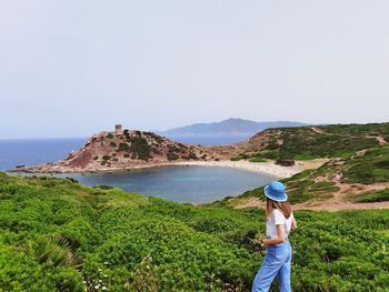 Man standing by sea against clear sky