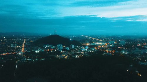 High angle view of illuminated buildings in city at night