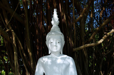 Statue of buddha against trees