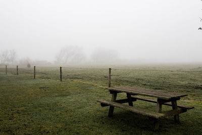 Scenic view of field against sky during foggy weather