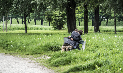 People relaxing on grassy field