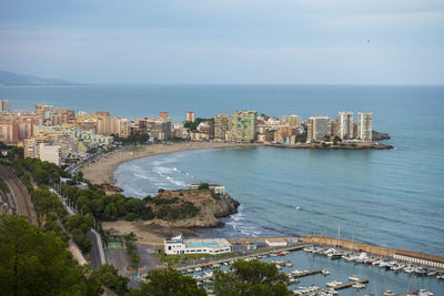 High angle view of sea and buildings against sky