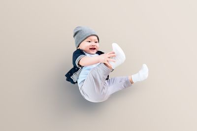 Boy playing against white background