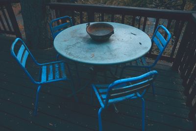 Empty chairs and table at sidewalk cafe