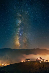 Scenic view of mountains against sky at night