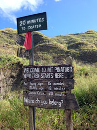 Close-up of signboard against sky