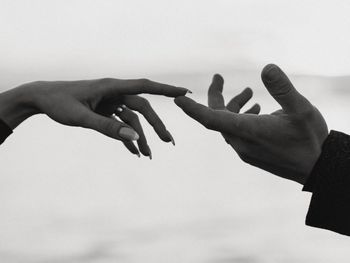 Cropped hand of person against white background