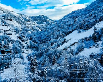 Scenic view of snow covered mountains against sky