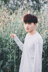 Portrait of young man standing on land