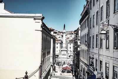 Street amidst buildings in town against sky