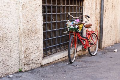 Bicycle parked against wall in city