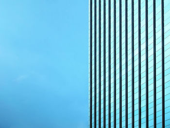 Low angle view of modern building against clear blue sky