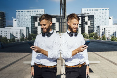 Young man standing in city