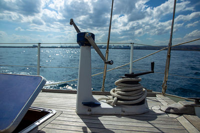 Nautical vessel on pier by sea against sky