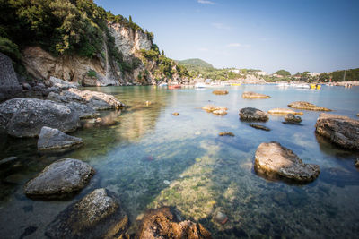 Rocks in sea against sky