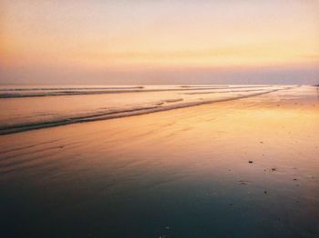 Scenic view of beach against sky during sunset