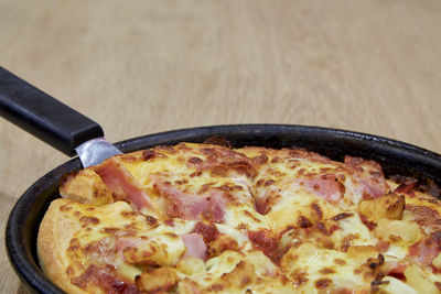 Close-up of pizza in cooking pan
