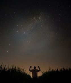 Low angle view of silhouette trees against sky at night
