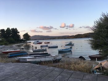 Boats moored in lake against sky