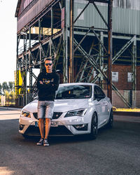 Portrait of man standing in car