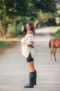 Side view of woman walking on road