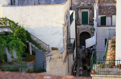 People on street amidst buildings in city