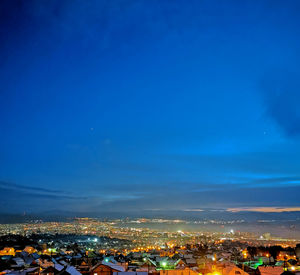 High angle shot of illuminated townscape against sky at night