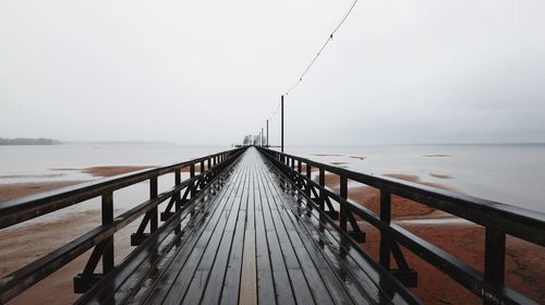 Pier on sea against sky