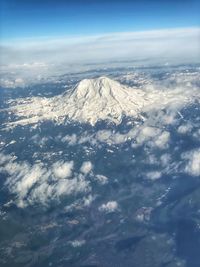 Aerial view of snowcapped mountains against sky