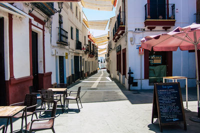 Empty alley amidst buildings in city