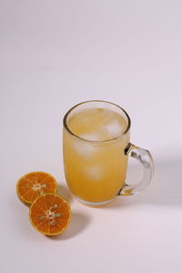 Close-up of orange juice against white background