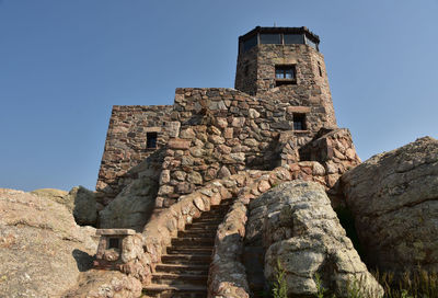 Stone observation tower on top of harney peak in the black hills.